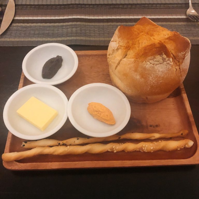 レストランのお通しは焼き立てのパン、バター、アンチェビソース、明太子の味がするソースでした。