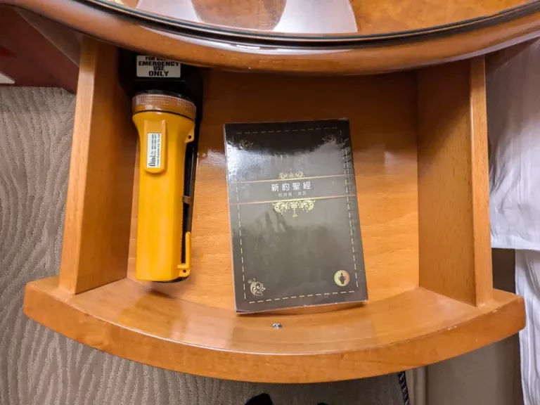 ベッドサイドテーブルの引き出しに聖書と懐中電灯